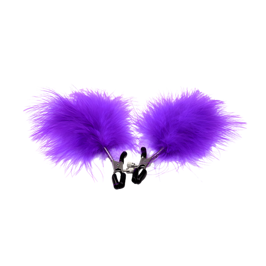 Purple fluffy feather attached to nipple clips on a white background